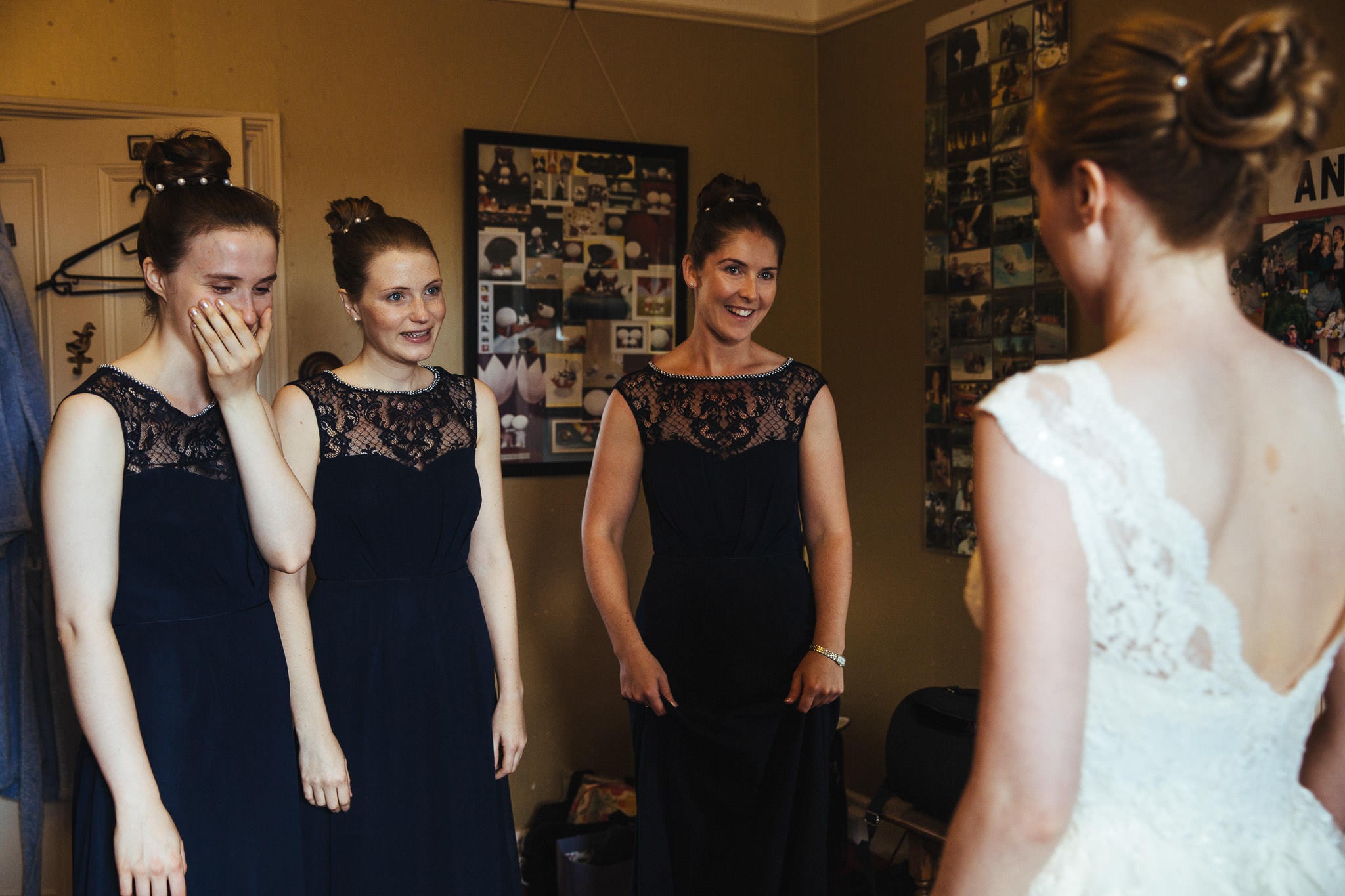 bridesmaids seeing bride in her dress