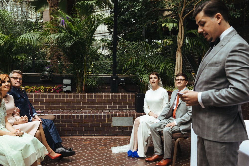 a wedding ceremony inside the Barbican Conservatory