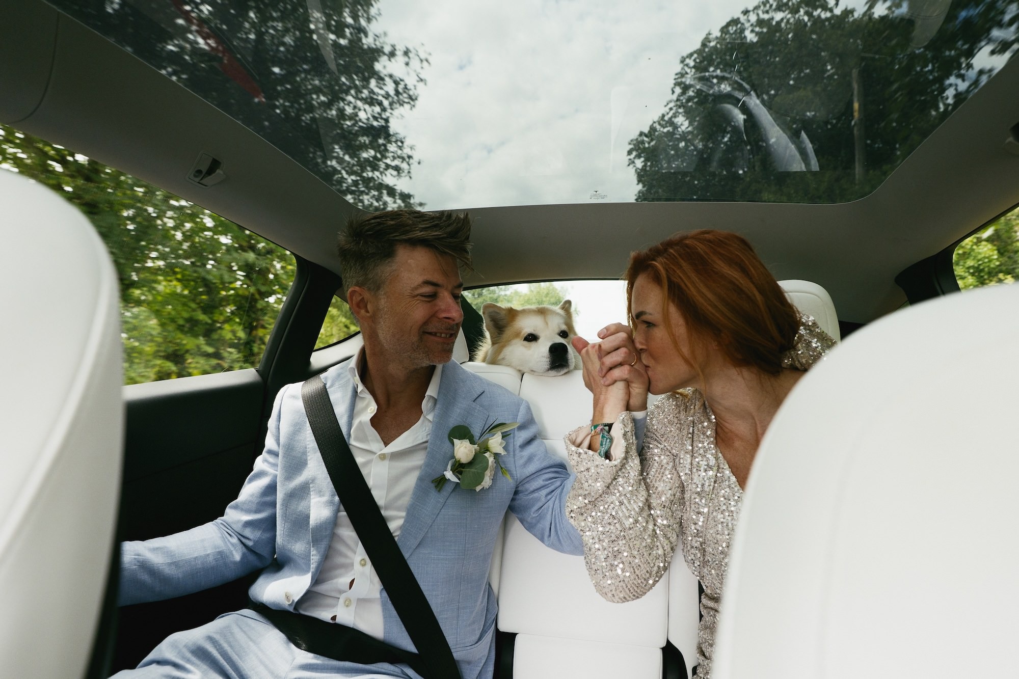bride and groom travel to the ceremony with their dog